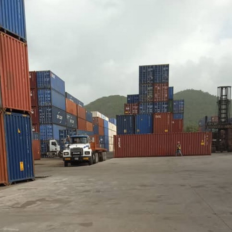 Scrap metal containers being loaded onto a cargo ship